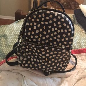 Backpack purse with flowers on it.